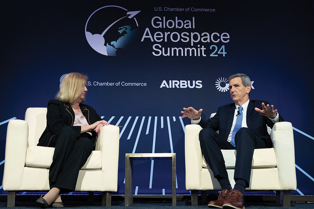 Karen Walker (left) and Michael G. Whitaker (right) talking while sitting in chairs