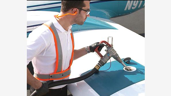 man refueling small airplane