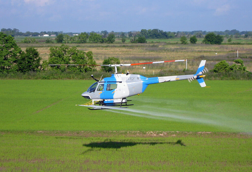 Helicopter treats a field