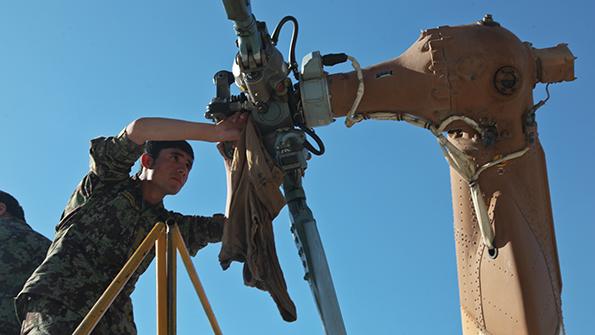 soldier servicing a rotor blade