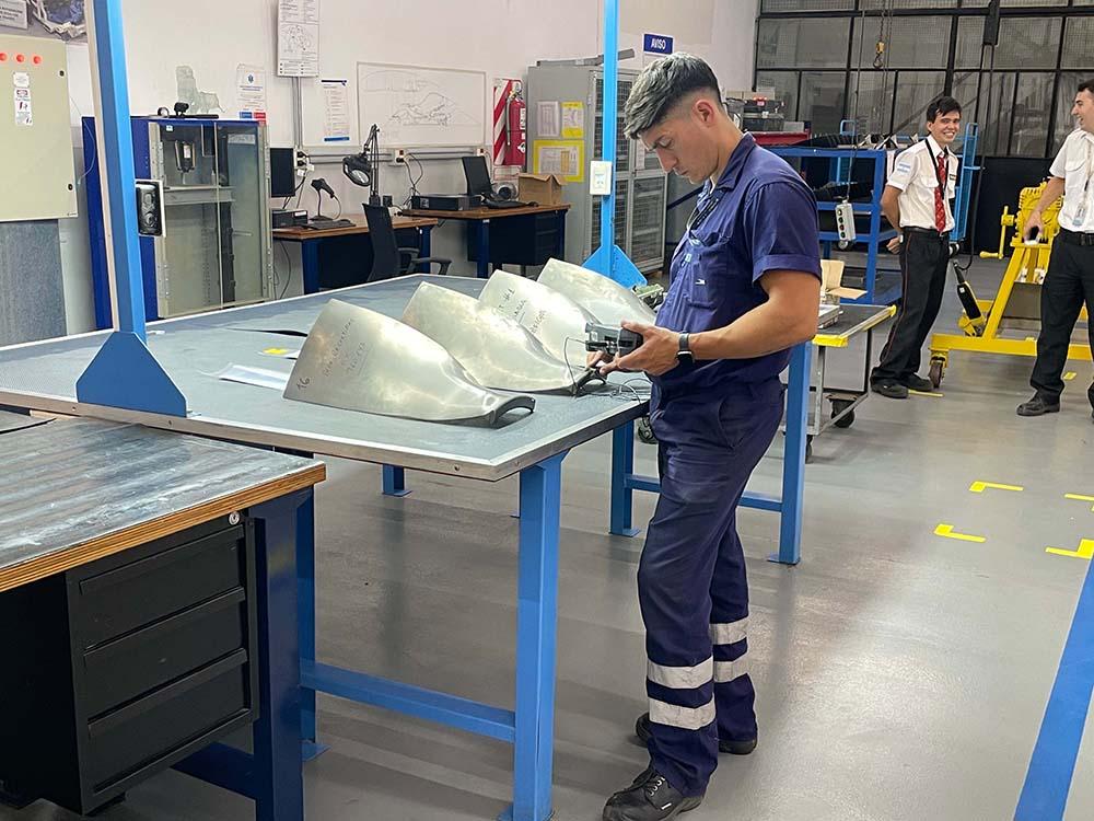 Mechanic performing engine maintenance