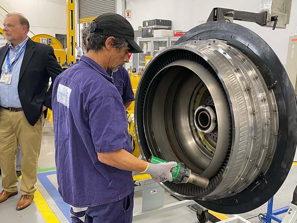 Technician performing engine maintenance