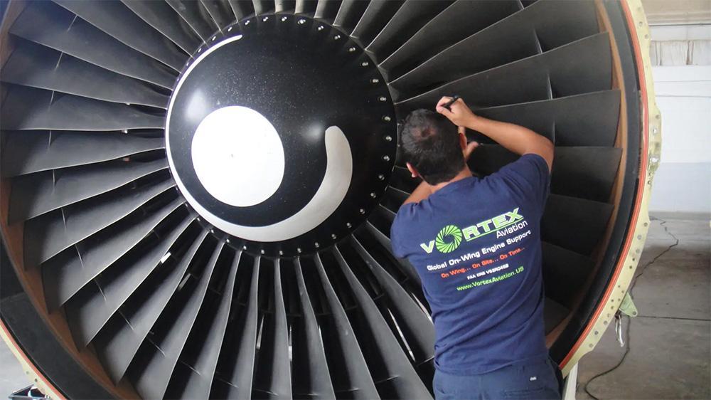 Vortex Aviation technician working on engine