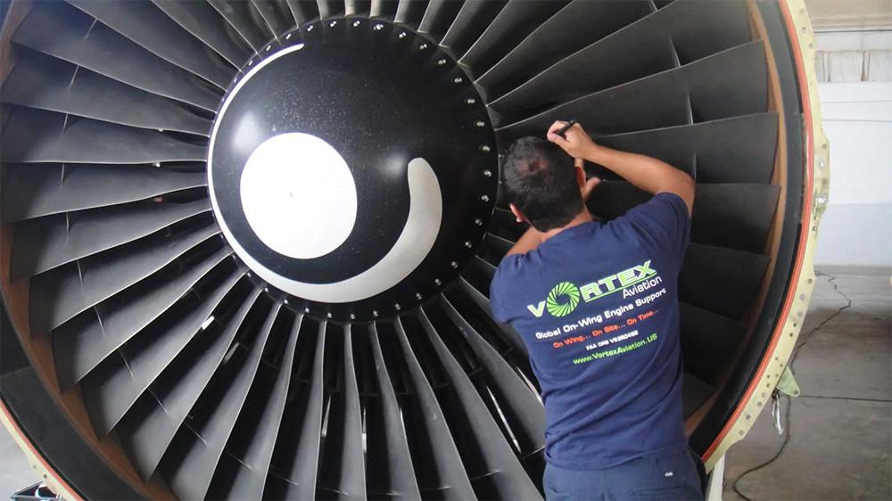 Technician working on engine