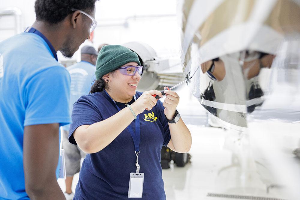 AIM student working on aircraft