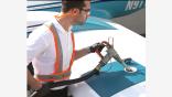 man refueling small airplane