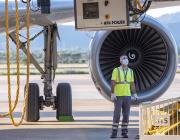 maintenance technician in front of aircraft and engine